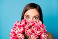 Close up photo of positive crazy funky girl hide her face with many tulips flowers impressed by 8-march 14-february gift Royalty Free Stock Photo
