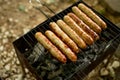 Close up photo of preparation of sausages on barbecue grill Royalty Free Stock Photo