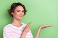 Close up photo of pretty cute lady striped trendy outfit arm direct empty space advert sale shopping isolated on green