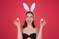 Close up photo of pretty girl wear easter fluffy bunny ears hold easter eggs, isolated studio background. Eater portrait