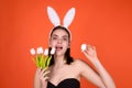 Close up photo of pretty girl wear easter fluffy bunny ears hold easter eggs, isolated studio background. Eater portrait