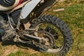 Close up photo of a professional motocross rider in action, showcasing the tire and various components of the motorcycle Royalty Free Stock Photo