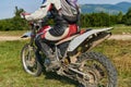 Close up photo of a professional motocross rider in action, showcasing the tire and various components of the motorcycle Royalty Free Stock Photo