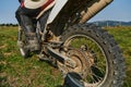 Close up photo of a professional motocross rider in action, showcasing the tire and various components of the motorcycle Royalty Free Stock Photo