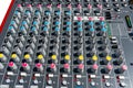 Close up photo of a professional sound mixer with many adjustments, knob switches and buttons of audio mixer control panel. Royalty Free Stock Photo