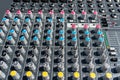 Close up photo of a professional sound mixer with many adjustments, knob switches and buttons of audio mixer control panel. Royalty Free Stock Photo