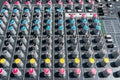 Close up photo of a professional sound mixer with many adjustments, knob switches and buttons of audio mixer control panel. Royalty Free Stock Photo