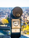 A close up photo of a public monocular on the top of a mountain with spectacular aerial views of the old city of Verona in Italy.