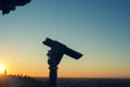 A close up photo of a public monocular on the top of a mountain with spectacular aerial views of the old city of Verona in Italy.