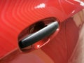 Close up photo of red car door handle. Royalty Free Stock Photo