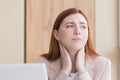 Close-up photo of a red haired business woman with a severe toothache and a headache at the computer, overwork, stress Royalty Free Stock Photo