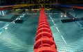 Close up photo of red lane line in empty swimming pool at night with lower light, symmetrical perspective view