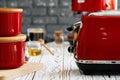 Close up photo of a red toaster on a kitchen table Royalty Free Stock Photo