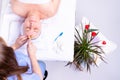 Close-up photo of a relaxes woman gets a face massage lying on the massage table wrapped a white towel in spa salon Royalty Free Stock Photo