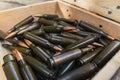 Close-up photo of rifle bullets stored in wooden box. Firearm ammunition. Military weaponry. Horizontal shot