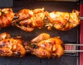 Close up photo of roasted chickens on spits in a grill Royalty Free Stock Photo