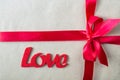 Close up photo of a romantic present with red ribbon and Love lettering Royalty Free Stock Photo