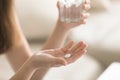 Close up photo of round white pill in female hand