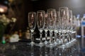 photo of rows of empty glasses for champagne on the table