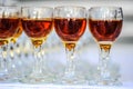 photo of rows of glasses with cognac on the table