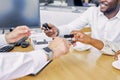 Close-up photo of sales agent`s hand giving keys of new car to customers Royalty Free Stock Photo