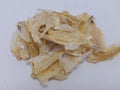 this is a close-up photo of salted fish crackers spread out on white paper