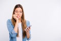 Close up photo of scared disappointed lady holding telephone in hand looking at screen isolated grey background