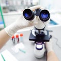 Close-up photo of scientist hands with microscope, examining sam Royalty Free Stock Photo