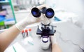 Close-up photo of scientist hands with microscope, examining samples and liquid Royalty Free Stock Photo