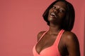 Close up photo of sensual african girl in pink bra looking at the camera, isolated over background Royalty Free Stock Photo