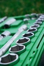 Chrome mechanics tools set. Close-up photo of a set of sockets with a screwdriver and a ratchet in a green plastic case against a Royalty Free Stock Photo