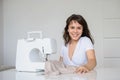 Photo of a sexy brunette working at the sewing machine Royalty Free Stock Photo