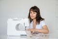 Photo of a sexy brunette working at the sewing machine Royalty Free Stock Photo