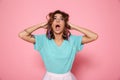 Close-up photo of shocked pretty girl in mint tshirt holding her