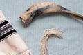 A close-up photo of a shofar and tallit,