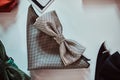 Close-up photo of a silk bow ties different colors on table in a menswear store.