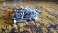 a close up photo of a silver bolt on a wooden table