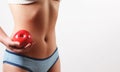 Close up. slender slim figure waist belly young woman girl. Holding a juicy red Apple isolated on white Royalty Free Stock Photo