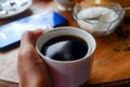 Close-up photo of someone drinking tea in the front yard of his house Royalty Free Stock Photo