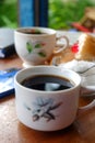 Close-up photo of someone drinking tea in the front yard of his house Royalty Free Stock Photo