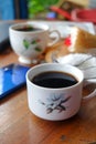 Close-up photo of someone drinking tea in the front yard of his house Royalty Free Stock Photo