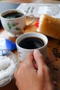 Close-up photo of someone drinking tea in the front yard of his house Royalty Free Stock Photo