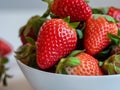 close-up photo of a stawberry in a white bowl