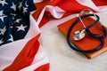 Close-up Photo Of Stethoscope and the red book On American Flag. medicine USA. Education concept. medical degree Royalty Free Stock Photo