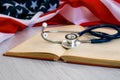 Close-up Photo Of Stethoscope and the red book On American Flag. medicine USA. Education concept. medical degree Royalty Free Stock Photo