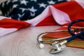Close-up Photo Of Stethoscope and the red book On American Flag. medicine USA. Education concept. medical degree Royalty Free Stock Photo