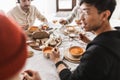 Close up photo of tabale full of food. Group of international friends having lunch spending time together in cafe Royalty Free Stock Photo