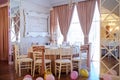 photo of a table in a banquet hall in white and brown colors decorated for the event Royalty Free Stock Photo