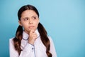 Close up photo of thoughtful kid have dilemma difficult test touch chin wear white blouse isolated over blue background Royalty Free Stock Photo