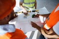 Close up of three man engineers looking at blueprint on construction site Royalty Free Stock Photo